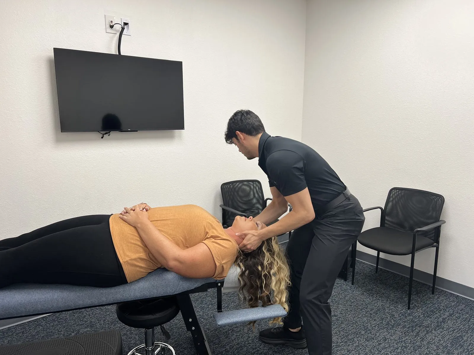 Dr. Jaycob Holohan adjusting a patient in the Burleson practice