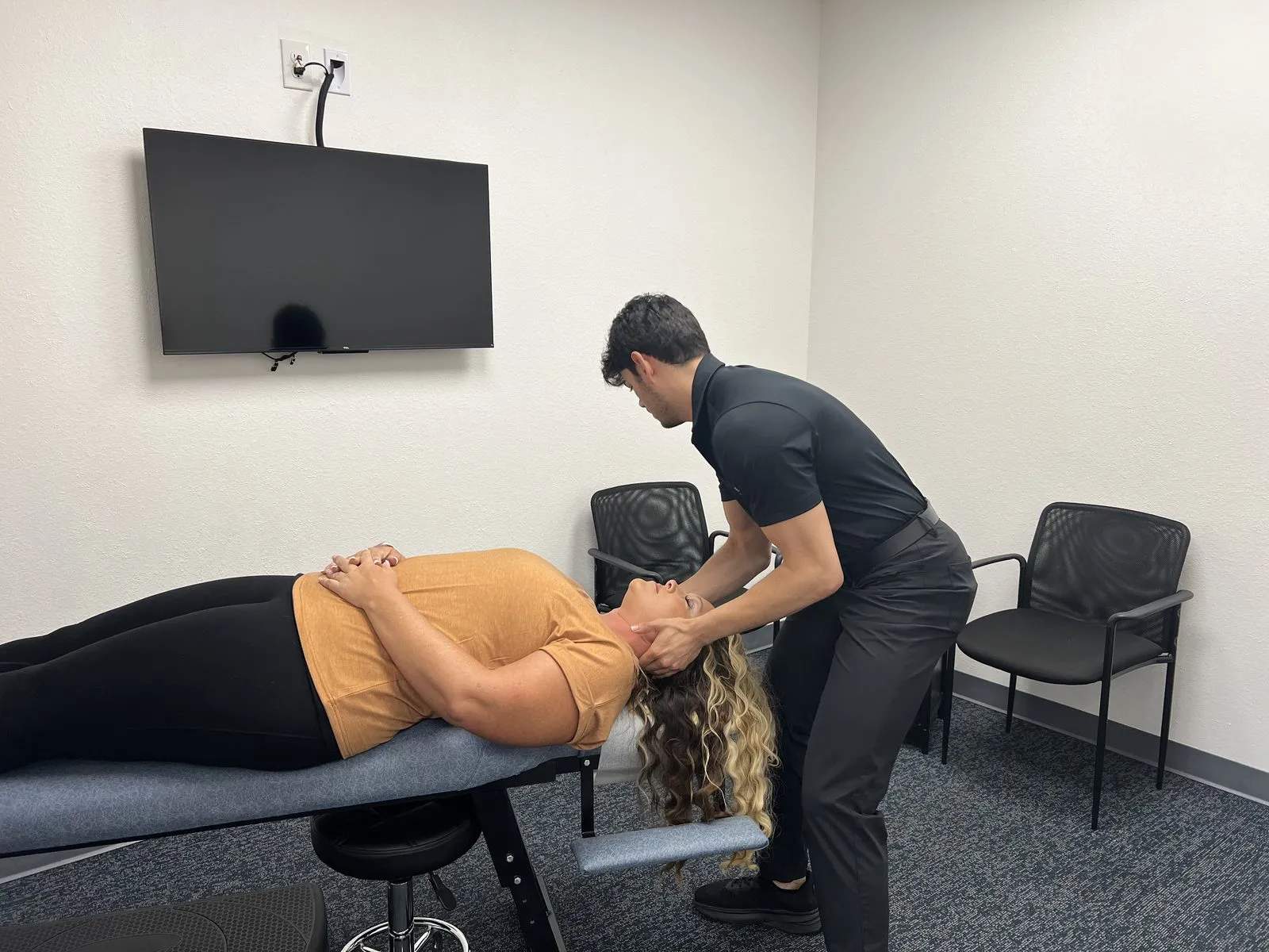 Dr. Jaycob Holohan adjusting a patient in the Burleson practice